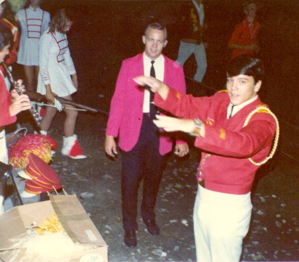 Me as high school drum major leading the band in the stands at a football game